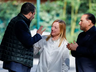 FILE PHOTO: Former Italian Prime Minister and leader of the Forza Italia party Silvio Berlusconi looks on as League leader Matteo Salvini speaks to Brothers of Italy leader Giorgia Meloni at the end of their meeting in Rome, Italy, October 20, 2021. REUTERS/Guglielmo Mangiapane/File Photo