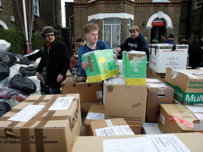 Volunteers prepare boxes of donated food, clothing and other essential items, to be sent to Ukrainian refugees in Poland, following Russia's invasion of Ukraine, at the Lewisham Polish Centre, in London, Britain, March 6, 2022. REUTERS/Peter Nicholls? - RC22XS9I9PJ1