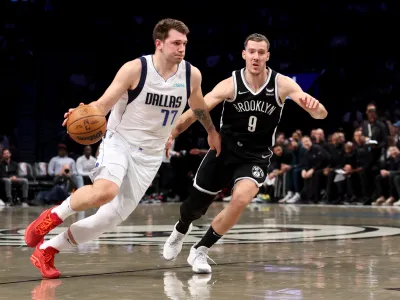 Mar 16, 2022; Brooklyn, New York, USA; Dallas Mavericks guard Luka Doncic (77) controls the ball against Brooklyn Nets guard Goran Dragic (9) during the first quarter at Barclays Center. Mandatory Credit: Brad Penner-USA TODAY Sports