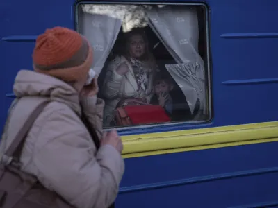 Ludmila, left, says goodbye to her granddaughter Kristina, who with her son Yaric, leave the train station in Odesa, southern Ukraine, on Tuesday, March 22, 2022. The U.N. refugee agency says more than 3.5 million people have fled Ukraine since Russia's invasion. (AP Photo/Petros Giannakouris)