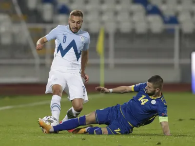 Soccer Football - UEFA Nations League - League C - Group 3 - Kosovo v Slovenia - Fadil Vokrri Stadium, Pristina, Kosovo - October 11, 2020. Slovenia's Sandi Lovric in action with Kosovo's Valon Berisha REUTERS/Florion Goga - UP1EGAB1JE0IQ