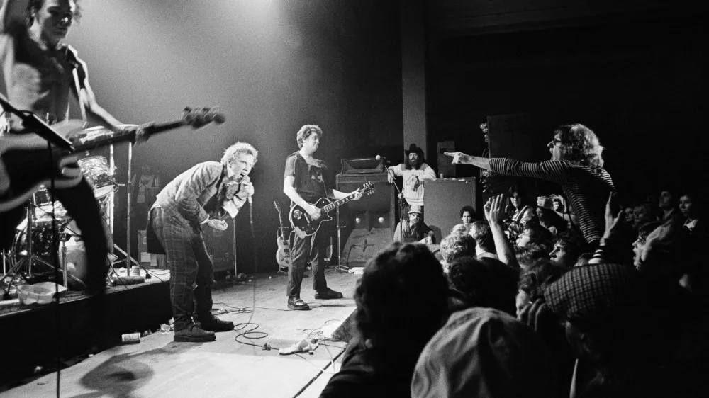 English punk rock group "Sex Pistols" get a form of audience participation on January 7, 1978 in Memphis, Tenn., during the second stop of their American tour. In left foreground is bass player Sid Vicious while group leader Johnny Rotten crouches in foreground. (AP Photo)