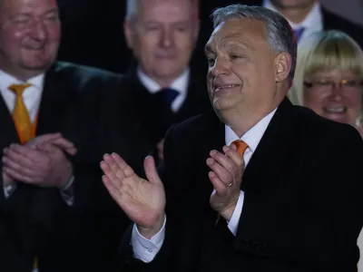 Hungary's Prime Minister Viktor Orban acknowledges cheering supporters during an election night rally in Budapest, Hungary, Sunday, April 3, 2022. Early partial results in Hungary's national election are showing a strong lead for the right-wing party of pro-Putin nationalist Orban as he seeks a fourth consecutive term. (AP Photo/Petr David Josek)
