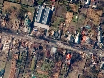 This satellite image provided by Maxar Technologies shows an overview of destroyed houses and vehicles in a street in Bucha, Ukraine on Thursday March 31, 2022. (Satellite image &copy;2022 Maxar Technologies via AP)