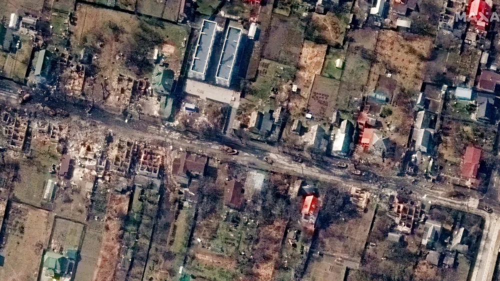 This satellite image provided by Maxar Technologies shows an overview of destroyed houses and vehicles in a street in Bucha, Ukraine on Thursday March 31, 2022. (Satellite image &copy;2022 Maxar Technologies via AP)