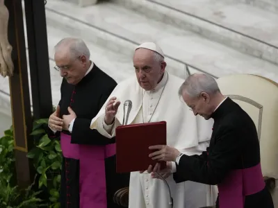 Pope Francis delivers his blessing during an audience with the members of the Italian Prosecutors High Council, in the Paul VI hall at the Vatican, Friday, April 8, 2022. (AP Photo/Alessandra Tarantino)