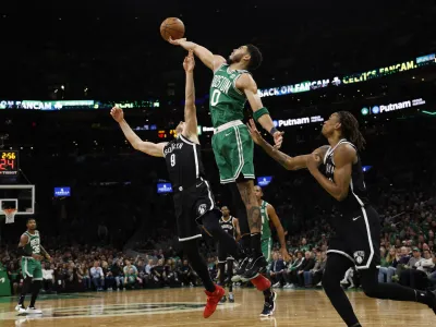 Apr 20, 2022; Boston, Massachusetts, USA; Boston Celtics forward Jayson Tatum (0) reaches for a rebound over Brooklyn Nets guard Goran Dragic (9) during the second quarter of game two of the first round of the 2022 NBA playoffs at TD Garden. Mandatory Credit: Winslow Townson-USA TODAY Sports