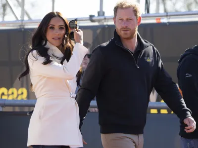Prince Harry and Meghan Markle, Duke and Duchess of Sussex visit the track and field event at the Invictus Games in The Hague, Netherlands, Sunday, April 17, 2022. The week-long games for active servicemen and veterans who are ill, injured or wounded opened Saturday in this Dutch city that calls itself the global center of peace and justice. (AP Photo/Peter Dejong)