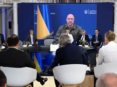 Ukrainian Prime Minister Denys Shmyhal is visible on a screen during the finance ministers and central bank chiefs meeting of the Group of 7 (G7) most industrialised nations in Koenigswinter, near Bonn, Germany May 19, 2022.   Federico Gambarini/Pool via REUTERS