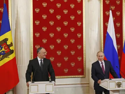 Russian President Vladimir Putin, right, and Moldovan President Igor Dodon hold a joint news conference in the Kremlin in Moscow, Russia, Tuesday, Jan. 17, 2017. Moldova's new president, who is visiting Russia on his first trip abroad, is voicing hope for rebuilding "strategic" ties with Moscow. (Sergei Ilnitsky/Pool Photo via AP)