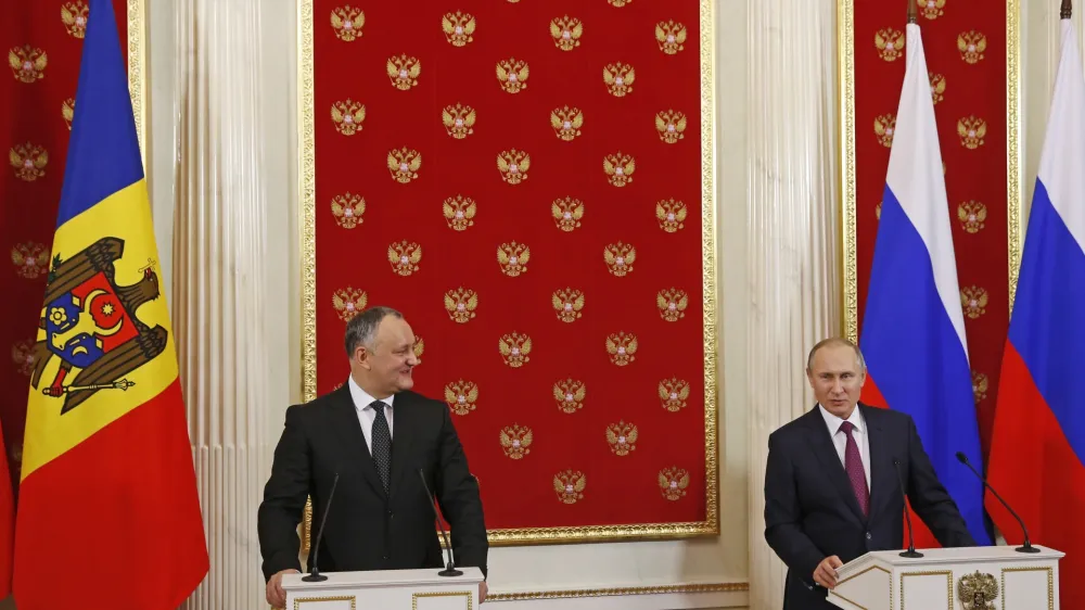 Russian President Vladimir Putin, right, and Moldovan President Igor Dodon hold a joint news conference in the Kremlin in Moscow, Russia, Tuesday, Jan. 17, 2017. Moldova's new president, who is visiting Russia on his first trip abroad, is voicing hope for rebuilding "strategic" ties with Moscow. (Sergei Ilnitsky/Pool Photo via AP)