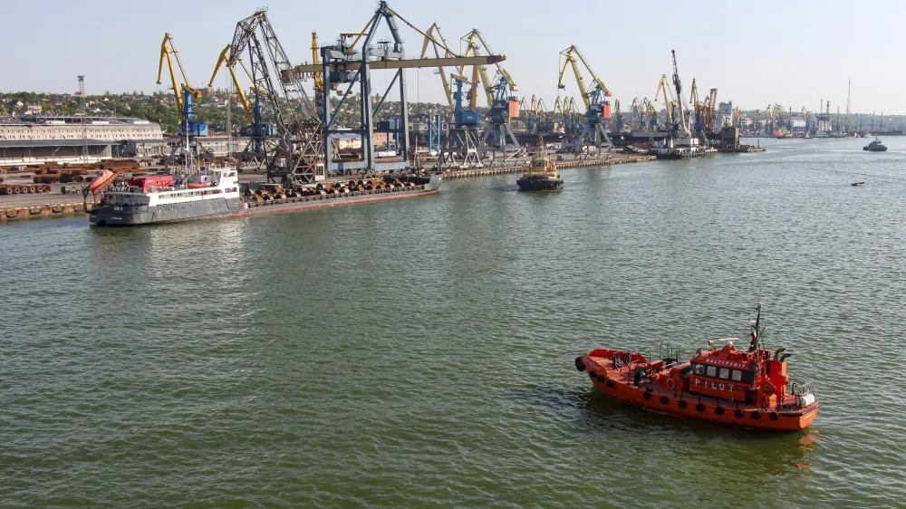 A Russian vessel, top left, prepares to depart from the Mariupol Sea Port in Mariupol, in territory under the government of the Donetsk People's Republic, eastern Ukraine, Tuesday, May 31, 2022. It marked the first time that a commercial ship used the port of Mariupol since the start of the Russian military action in Ukraine. (AP Photo)