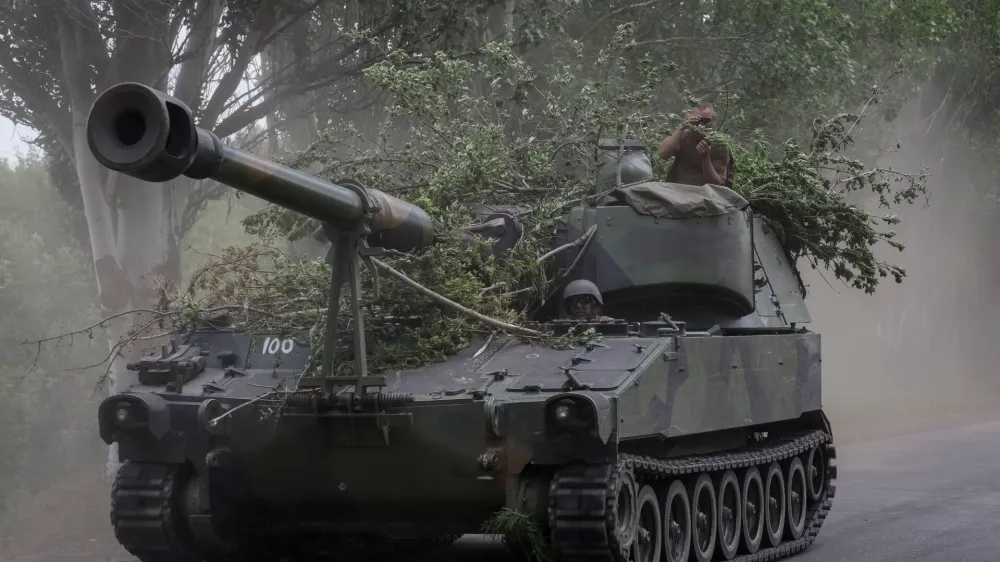 Ukrainian servicemen ride an American 155 mm turreted self-propelled howitzer M109, amid Russia's attack on Ukraine, in Donetsk region, Ukraine June 13, 2022. REUTERS/Gleb Garanich