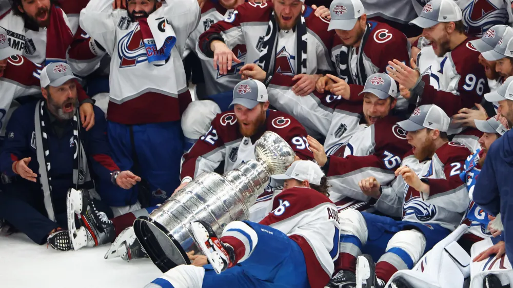 Jun 26, 2022; Tampa, Florida, USA; The Colorado Avalanche players react as right wing Nicolas Aube-Kubel (16) falls and drops the Stanley Cup trophy on the ice after defeating the Tampa Bay Lightning to win the Stanley Cup in game six of the 2022 Stanley Cup Final at Amalie Arena. Mandatory Credit: Mark J. Rebilas-USA TODAY Sports
