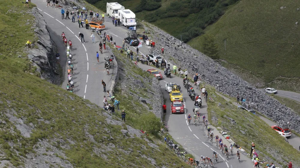 The pack climbs Galibier pass during the 19th stage of the Tour de France cycling race over 109.5 kilometers (86 miles) starting in Modane Valfrejus and finishing on Alpe d'Huez, Alps region, France, Friday July 22, 2011. (AP Photo/Christophe Ena)