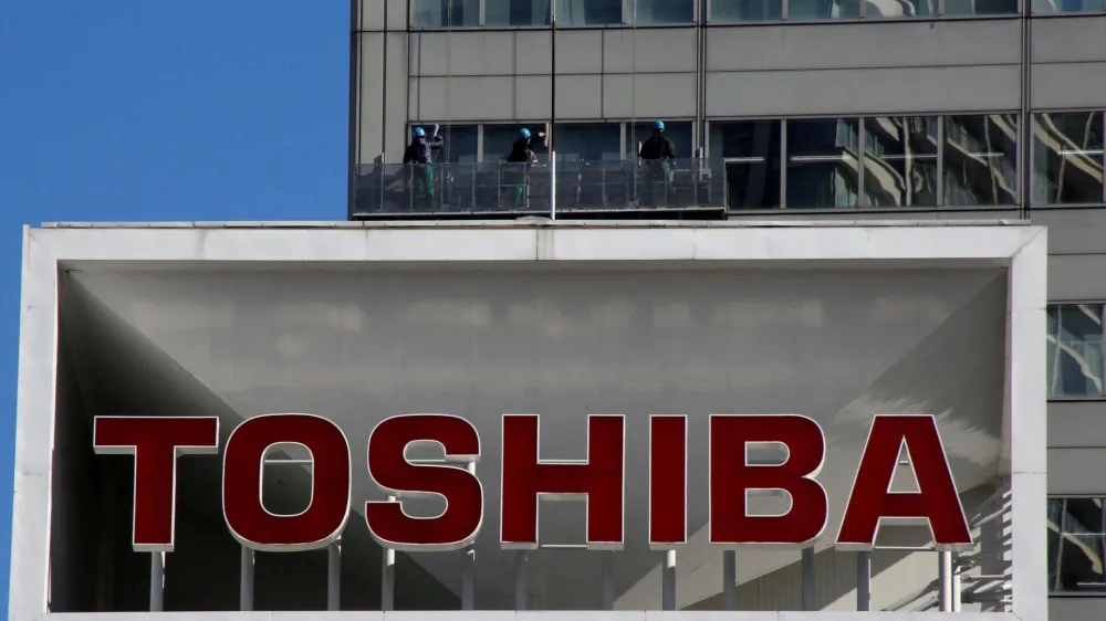 FILE PHOTO: The logo of Toshiba Corp is seen as window cleaners work on the company's headquarters in Tokyo, Japan, February 14, 2017. REUTERS/Toru Hanai/File Photo