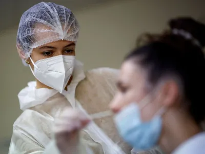 FILE PHOTO: A medical worker administers a nasal swab to a patient at a coronavirus disease (COVID-19) testing centre in Les Sorinieres, near Nantes, France, June 23, 2022. REUTERS/Stephane Mahe/File Photo