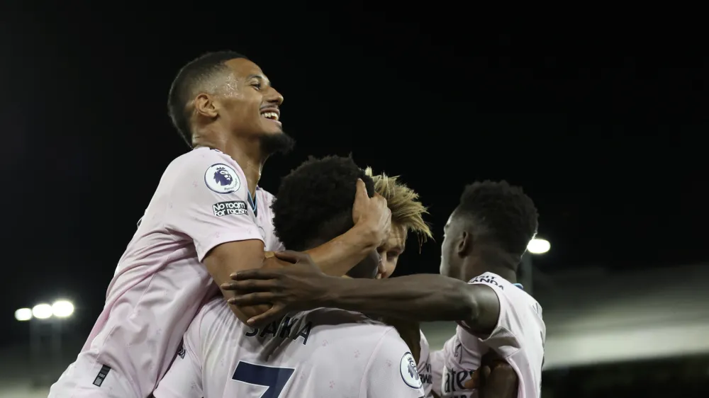 Arsenal players celebrate after Crystal Palace's Marc Guehi scores an own goal past his goalkeeper during the English Premier League soccer match between Crystal Palace and Arsenal at Selhurst Park stadium in London, Friday, Aug. 5, 2022. (AP Photo/Ian Walton)