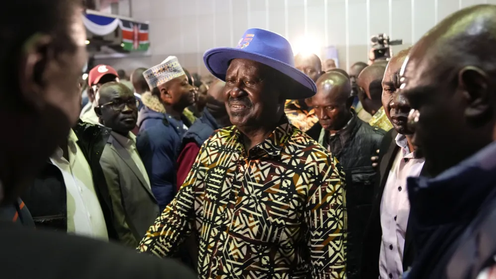 Kenyan presidential candidate Raila Odinga, center, walks through the crowd during departure after delivering an address to the nation at his campaign headquarters in downtown Nairobi, Kenya, Tuesday, Aug. 16, 2022. Kenya is calm a day after Deputy President William Ruto was declared the winner of the narrow presidential election over longtime opposition figure Raila Odinga. (AP Photo/Ben Curtis)