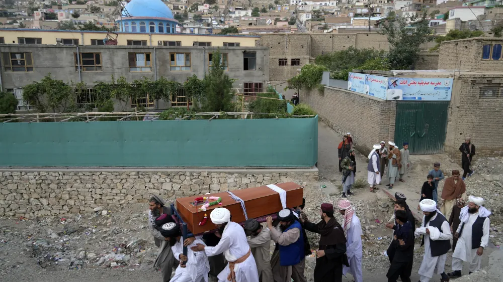 Mourners carry the body of a victim of a mosque bombing in Kabul, Afghanistan, Thursday, Aug. 18. 2022. A bombing at a mosque in Kabul during evening prayers on Wednesday killed at least 10 people, including a prominent cleric, and wounded over two dozen, an eyewitness and police said. (AP Photo/Ebrahim Noroozi)