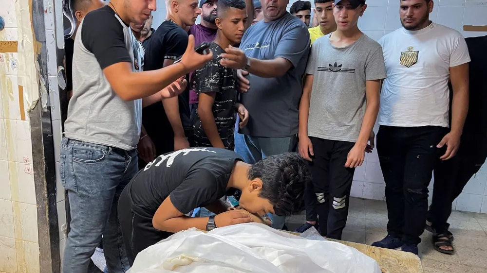 SENSITIVE MATERIAL. THIS IMAGE MAY OFFEND OR DISTURB People react next to the body of Palestinian Waseem Khalifa, 18, who was killed by Israeli forces during clashes in a raid, in Nablus in the Israeli-occupied West Bank, August 18, 2022. REUTERS/Adel Abu Nemeh NO RESALES. NO ARCHIVES