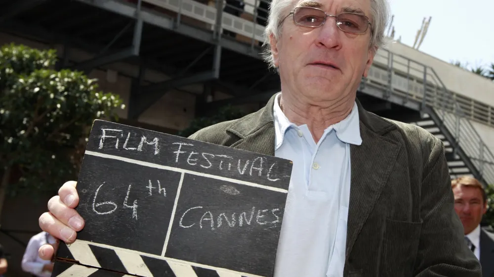 Actor Robert De Niro, president of the jury of the 64th Cannes Film Festival, holds a film clapper in Cannes May 11, 2011. The film festival runs from May 11 to 22.    REUTERS/Eric Gaillard (FRANCE - Tags: ENTERTAINMENT)