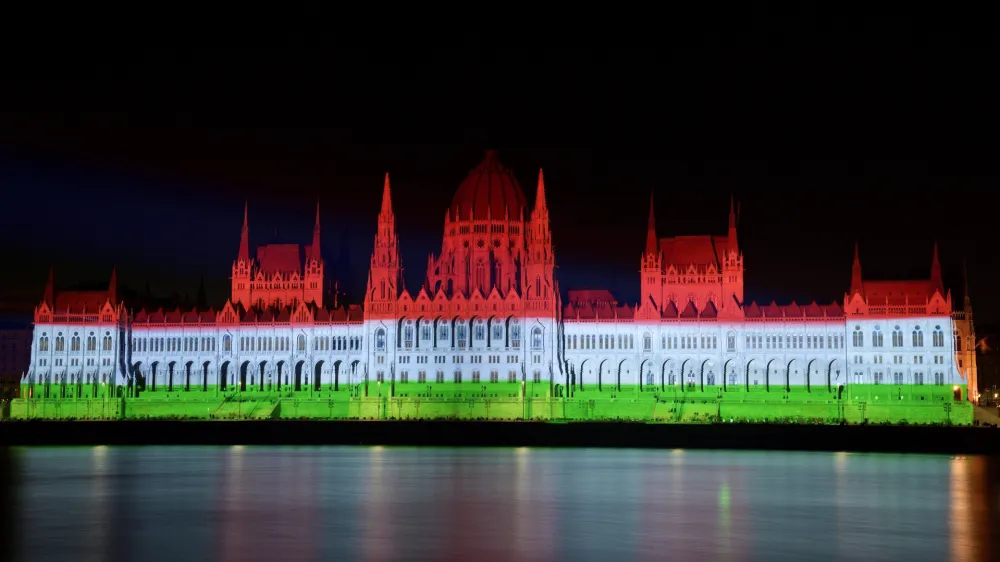 The colors of the Hungarian flag illuminate the Parliament building to mark the national holiday celebrating Hungary's statehood in Budapest, Hungary, Saturday, Aug. 20, 2022. State founder St. Stephen I, the first king of Hungary was crowned in 1000 A.D. (Peter Lakatos/MTI via AP)
