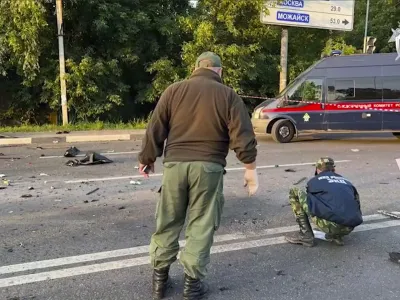 In this handout photo taken from video released by Investigative Committee of Russia on Sunday, Aug. 21, 2022, investigators work on the site of explosion of a car driven by Daria Dugina outside Moscow. Daria Dugina, the daughter of Alexander Dugin, the Russian nationalist ideologist often called "Putin's brain", was killed when her car exploded on the outskirts of Moscow, officials said Sunday. The Investigate Committee branch for the Moscow region said the Saturday night blast was caused by a bomb planted in the SUV driven by Daria Dugina.(Investigative Committee of Russia via AP)
