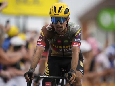 Slovenia's Primoz Roglic crosses the finish line with a delay on his main rival Slovenia's Tadej Pogacar during the fifth stage of the Tour de France cycling race over 157 kilometers (97.6 miles) with start in Lille Metropole and finish in Arenberg Porte du Hainaut, France, Wednesday, July 6, 2022. (AP Photo/Daniel Cole)