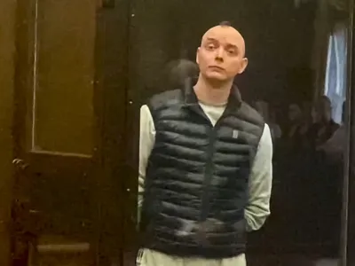 In this photo taken from video provided by the Moscow City Court, Ivan Safronov, an adviser to the director of Russia's state space corporation, right, stands in a court room prior to court session in Moscow, Russia, Monday, Sept. 5, 2022. A court in Moscow on Monday found the former journalist guilty of treason and sentenced him to 22 years in a maximum security prison, concluding a trial that has been widely seen as politically motivated. Safronov was accused of passing military secrets to Czech intelligence and information about the Russian military to a German national. The former journalist insisted on his innocence. (Moscow City Court via AP)