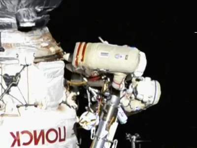 This image provided by NASA, Italian astronaut Samantha Cristoforetti and Russian cosmonaut Oleg Artemyev perform maintenance on the International Space Station on Thursday, July 21, 2022. Cristoforetti teamed up with Artemyev to work on the International Space Station's newest robot arm. The 37-foot (11-meter) mechanical limb _ contributed by the European Space Agency _ rocketed into orbit with a Russian lab last July.  (NASA via AP).