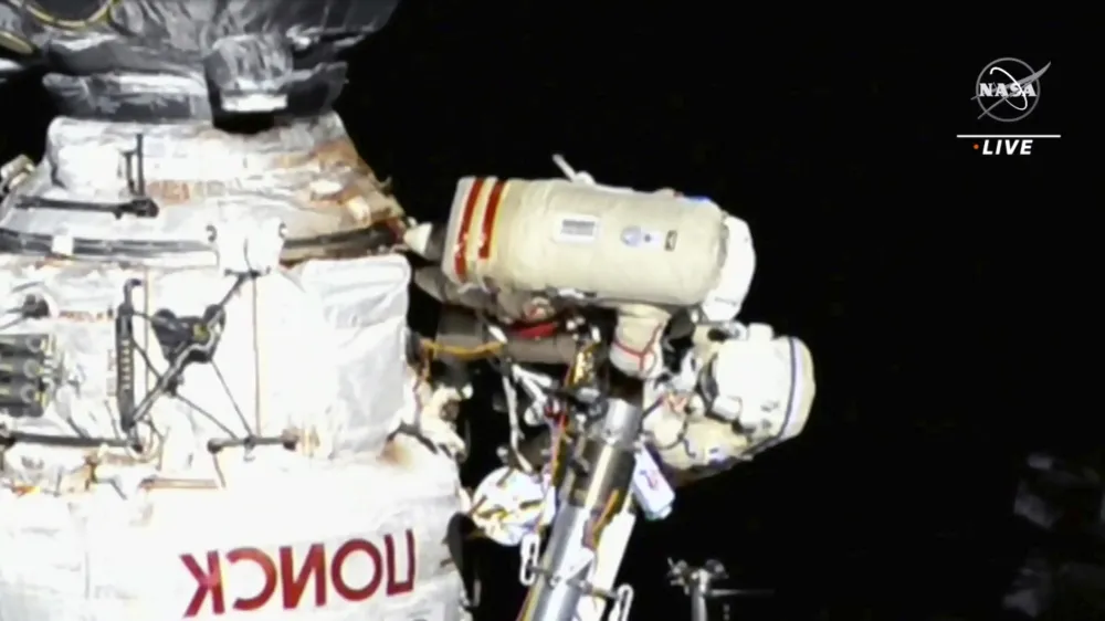 This image provided by NASA, Italian astronaut Samantha Cristoforetti and Russian cosmonaut Oleg Artemyev perform maintenance on the International Space Station on Thursday, July 21, 2022. Cristoforetti teamed up with Artemyev to work on the International Space Station's newest robot arm. The 37-foot (11-meter) mechanical limb _ contributed by the European Space Agency _ rocketed into orbit with a Russian lab last July.  (NASA via AP).