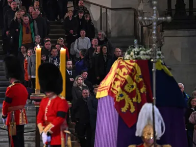 Members of the public pay their respects as they pass the coffin of Queen Elizabeth II, Lying in State inside Westminster Hall, at the Palace of Westminster in London, Sunday, Sept. 18, 2022. (Paul Ellis/Pool Photo via AP)