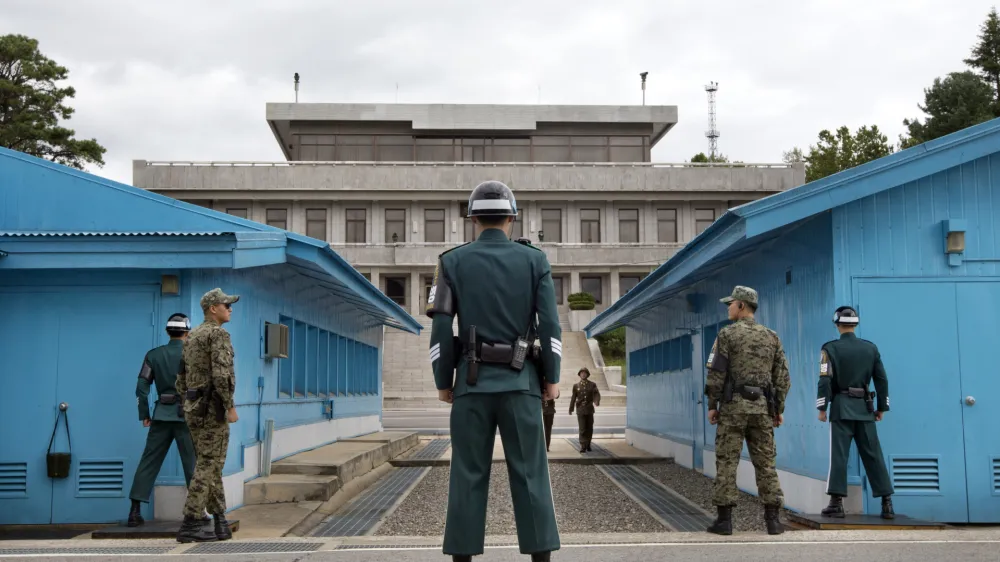 FILE - In this Sept. 30, 2013, file photo, South Korean soldiers look toward the North Korean side as a North Korean solder approaches the UN truce village building that sits on the border of the Demilitarized Zone (DMZ), the military border separating the two Koreas in Panmunjom, South Korea. The search is on for a venue to host a summit between President Donald Trump and North Korea&acirc;&euro;&trade;s Kim Jong Un. There are lots of caveats. Trump is being urged not to legitimize Kim by agreeing to talks in North Korea. And it&acirc;&euro;&trade;s risky for Kim to travel to the U.S. So the leaders are more likely to meet in a neutral place, such as the demilitarized zone between the Koreas. (AP Photo/Jacquelyn Martin, File)