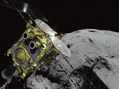 This computer graphics image provided by the Japan Aerospace Exploration Agency (JAXA) shows an asteroid and asteroid explorer Hayabusa2. The Japanese space explorer that will try to blow a crater in an asteroid and bring back samples from inside is nearing its destination after a 3 1/2 -year journey. The unmanned Hayabusa2 has arrived at the asteroid Wednesday, June 27, 2018, about 280 million kilometers (170 million miles) from Earth.(JAXA via AP)