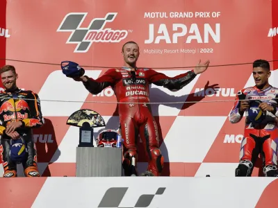 Motorcycling - MotoGP - Japanese Grand Prix - Suzuka Circuit, Suzuka, Japan - September 25, 2022 Ducati Lenovo's Jack Miller celebrates on the podium after winning the race alongside second placed Red Bull KTM Factory Racing's Brad Binder and third placed Pramac Racing's Jorge Martin REUTERS/Issei Kato