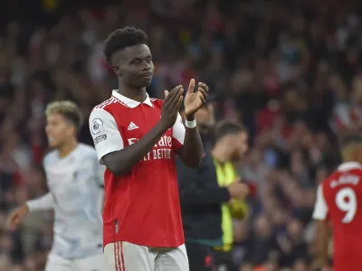 Arsenal's Bukayo Saka waves supporters at the end of the English Premier League soccer match between Arsenal and Liverpool at Emirates Stadium in London, Sunday, Oct. 9, 2022. Arsenal won 3-2. (AP Photo/Rui Vieira)