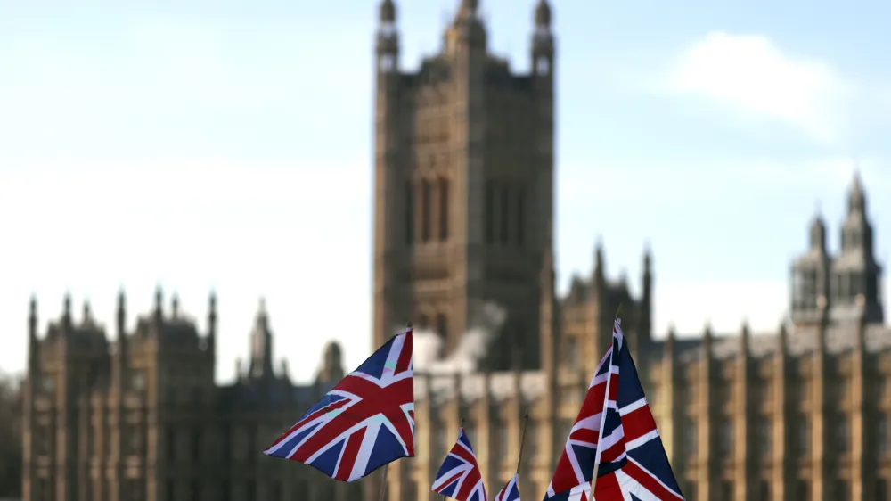 British Union flags fly in front of The Houses of Parliament in London, Tuesday, Jan. 22, 2019. British Prime Minister Theresa May launched a mission to resuscitate her rejected European Union Brexit divorce deal, setting out plans to get it approved by Parliament. (AP Photo/Frank Augstein)