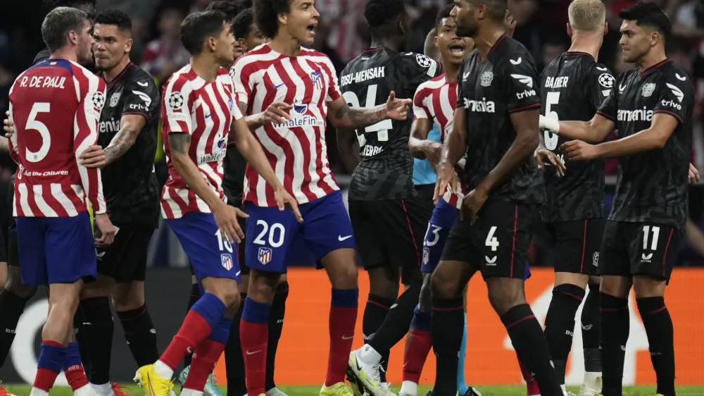 Teams' players argue during the group B Champions League soccer match between Atletico Madrid and Bayer 04 Leverkusen at the Civitas Metropolitano stadium in Madrid, Spain, Wednesday, Oct. 26, 2022. (AP Photo/Manu Fernaandez)