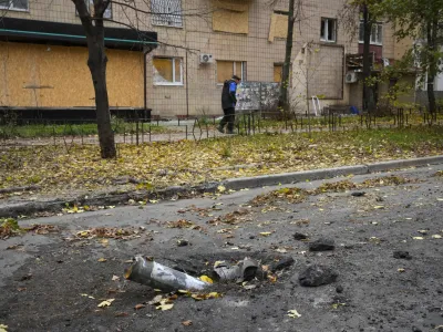 A man passes by fragments of a Russian rocket in central Bakhmut, the site of the heaviest battle against the Russian troops in the Donetsk region, Ukraine, Friday, Oct. 28, 2022. (AP Photo/Efrem Lukatsky)