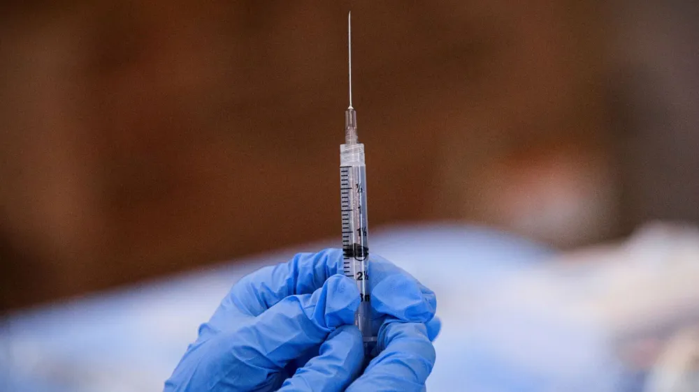 FILE PHOTO: A syringe is filled with a dose of Pfizer's coronavirus disease (COVID-19) vaccine at a pop-up community vaccination center at the Gateway World Christian Center in Valley Stream, New York, U.S., February 23, 2021. REUTERS/Brendan McDermid/File Photo
