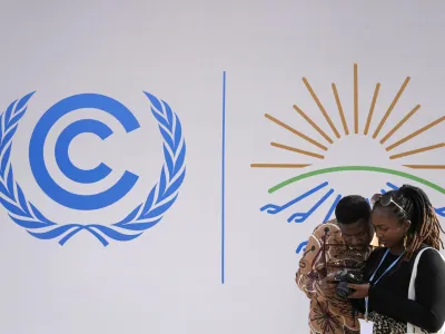Attendees look at images that they shot at the COP27 U.N. Climate Summit, Monday, Nov. 14, 2022, in Sharm el-Sheikh, Egypt. (AP Photo/Peter Dejong)