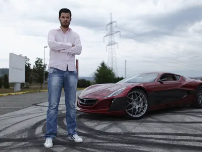Mate Rimac owner of Rimac Automobili poses with the Concept One car in Zagreb August 31, 2012. Croatian concept car manufacturer Rimac Automobili based near Zagreb prepares to unveil a prototype of their Concept One electric supercar at the upcoming Salon Priv&eacute; car show in London in early September.The Concept One has a carbon fiber body an electric motor powering each wheel, and can produce 1,088 horse powers, capable of achieving top speed of around 305 kmh (190 mph) with a range of 600 kilometres (373 miles), making it the world's fastest electric car. Costing around  million each, only 13 of these high-end electric cars are expected to be produced per year. Picture taken August 31, 2012. REUTERS/Antonio Bronic (CROATIA - Tags: TRANSPORT BUSINESS) - RTR37CTI