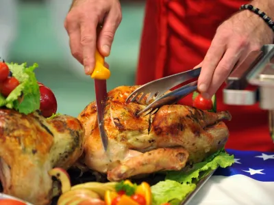 A chef cuts slices of a turkey during a presentation of traditional Thanksgiving dishes, in Macedonia's capital Skopje, on Wednesday, Nov. 4, 2009. The food presentation was organized by USA Poultry & Egg Export Council, a non-profit, industry-sponsored trade organization dedicated to increasing exports of United States poultry and egg food products. The food was prepared by Macedonian chefs by instructions of the U.S. culinary consultant and Chef David Bonom. (AP Photo/Boris Grdanoski)