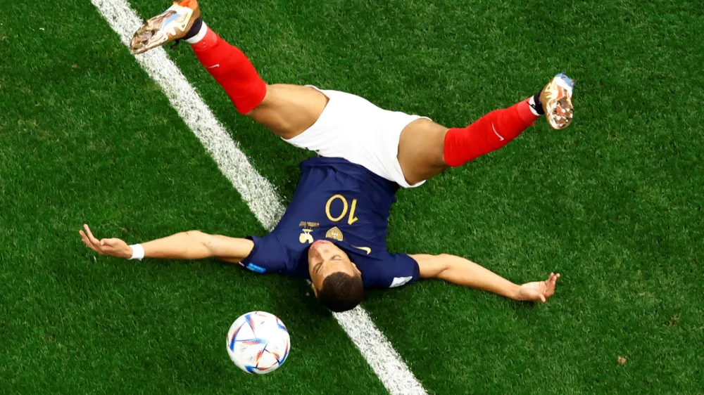 Soccer Football - FIFA World Cup Qatar 2022 - Quarter Final - England v France - Al Bayt Stadium, Al Khor, Qatar - December 10, 2022 France's Kylian Mbappe goes down REUTERS/Peter Cziborra   TPX IMAGES OF THE DAY