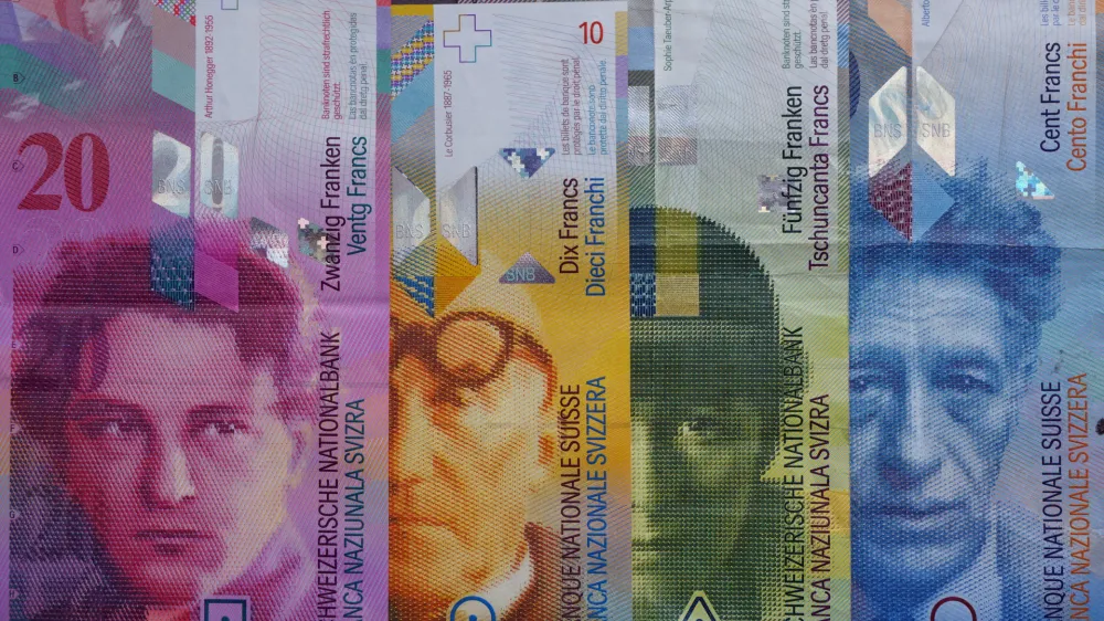 ILLUSTRATION - Banknotes of the Swiss franc currency sit on a table in Wengen, Switzerland, 04 August 2013. (R-L) 100 franc Alberto Giacometti, 50 franc Sophie Taeuber-Arp, 10 franc Le Corbusier, 20 francs Arthur Honeggerr. Photo by: Soeren Stache/picture-alliance/dpa/AP Images
