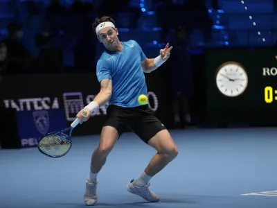 Norways' Casper Ruud returns the ball to Russia's Andrey Rublev during their ATP World Tour Finals singles tennis match, at the Pala Alpitour in Turin, Friday, Nov. 19, 2021. (AP Photo/Luca Bruno)