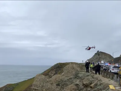 FILE - This image from video provided by Cal Fire San Mateo, Santa Cruz Unit, emergency personnel respond to the scene after a Tesla plunged off a cliff along the Pacific Coast Highway, Monday, Jan. 2, 2023, in Northern California, near an area known as Devil's Slide, leaving four people in critical condition, a fire official said. The driver of the Tesla that plunged off a cliff in Northern California, seriously wounding two children and a second adult, intentionally caused the crash and has been arrested on suspicion of attempted murder and child abuse, the California Highway Patrol said Tuesday, Jan. 3, 2023. (Cal Fire San Mateo - Santa Cruz Unit via AP, File)
