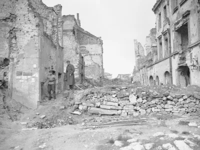File-this file photo from 1945 shows two German soldiers make their way through the gutted city of Warsaw, the capital of Poland, in September 1945. A Polish ruling party official said Wednesday that Poland is considering demanding reparations from Germany for the massive losses inflicted on Poland during World War II. Ruling party leader Jaroslaw Kaczynski recently said Poland planned a "counter-offensive" against Germany, accusing the neighbor of avoiding responsibility for its war-era crimes. (AP Photo/Henry Griffin)