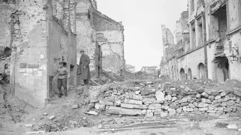 File-this file photo from 1945 shows two German soldiers make their way through the gutted city of Warsaw, the capital of Poland, in September 1945. A Polish ruling party official said Wednesday that Poland is considering demanding reparations from Germany for the massive losses inflicted on Poland during World War II. Ruling party leader Jaroslaw Kaczynski recently said Poland planned a "counter-offensive" against Germany, accusing the neighbor of avoiding responsibility for its war-era crimes. (AP Photo/Henry Griffin)